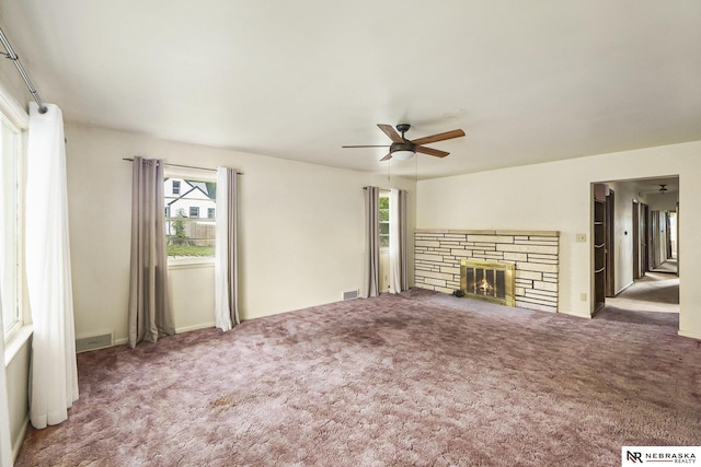 1801 Franklin St, Bellevue, NE 68005 - unfurnished living room with a ceiling fan, carpet flooring, a stone fireplace, and baseboards