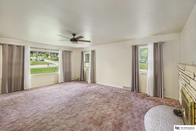1801 Franklin St, Bellevue, NE 68005 - unfurnished living room featuring plenty of natural light, ceiling fan, carpet, and a fireplace with flush hearth