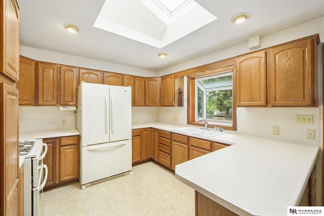 1801 Franklin St, Bellevue, NE 68005 - kitchen featuring white appliances, a sink, a skylight, a peninsula, and light countertops