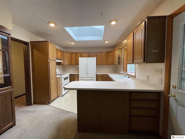 1801 Franklin St, Bellevue, NE 68005 - kitchen featuring white appliances, a sink, a skylight, a peninsula, and light countertops