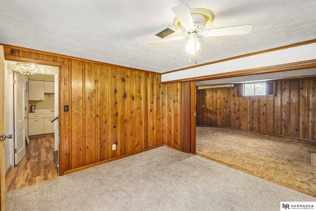 1801 Franklin St, Bellevue, NE 68005 - below grade area featuring carpet, wood walls, a ceiling fan, and a chandelier