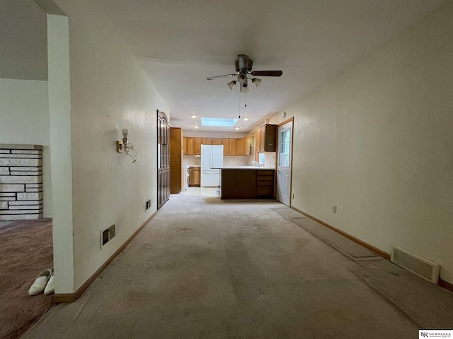 1801 Franklin St, Bellevue, NE 68005 - unfurnished living room featuring light colored carpet, ceiling fan, baseboards, and a sink
