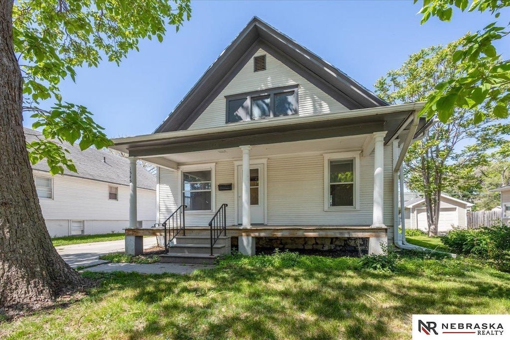 1545 Whittier St, Lincoln, NE 68503 - view of front of home featuring covered porch and a front lawn
