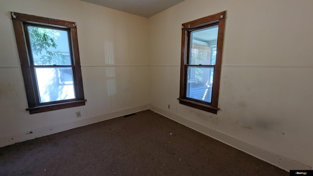 empty room with dark carpet