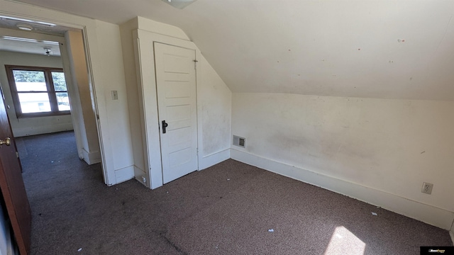 additional living space featuring vaulted ceiling, carpet flooring, and baseboards