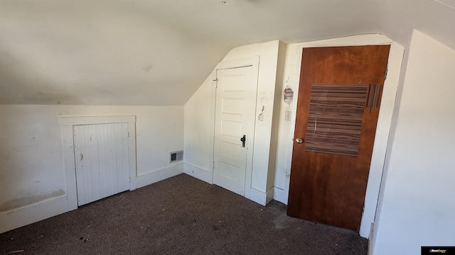 additional living space with carpet flooring and lofted ceiling