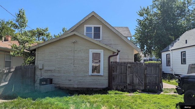 view of side of home with a gate
