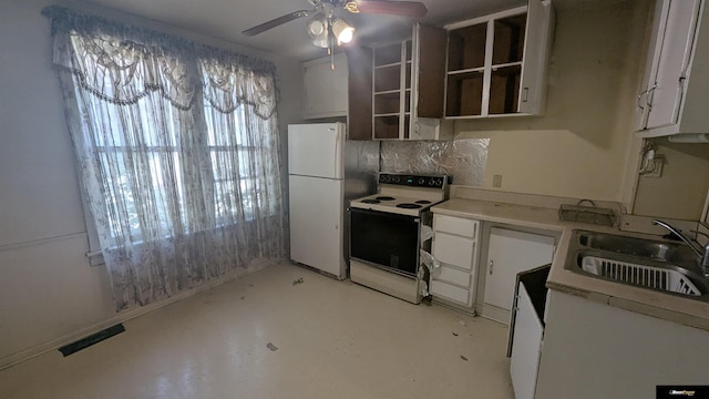 kitchen with white appliances, ceiling fan, a sink, and white cabinets