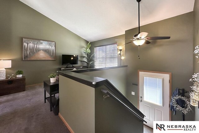 staircase with carpet floors, a ceiling fan, high vaulted ceiling, and baseboards