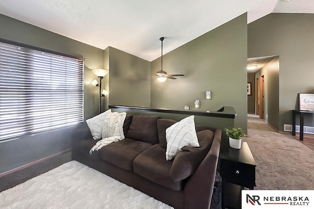 living area with carpet, ceiling fan, baseboards, and high vaulted ceiling