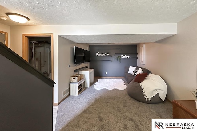 carpeted living room with a textured ceiling and baseboards