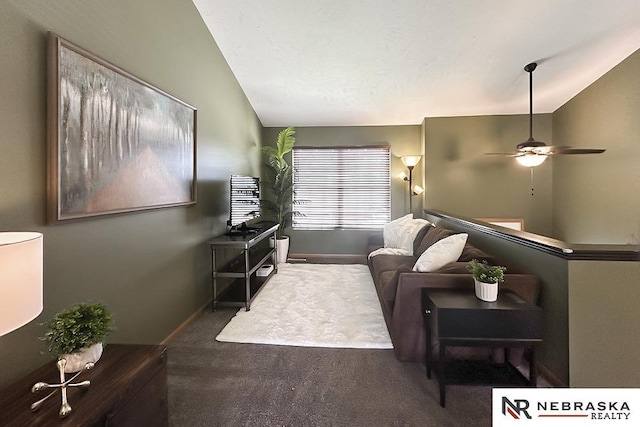 living area featuring lofted ceiling, ceiling fan, carpet floors, and baseboards