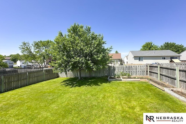 view of yard with a residential view and a vegetable garden