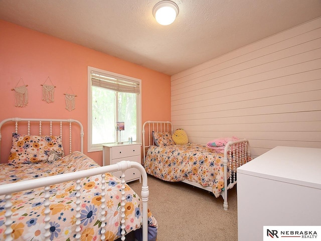 bedroom featuring carpet and refrigerator
