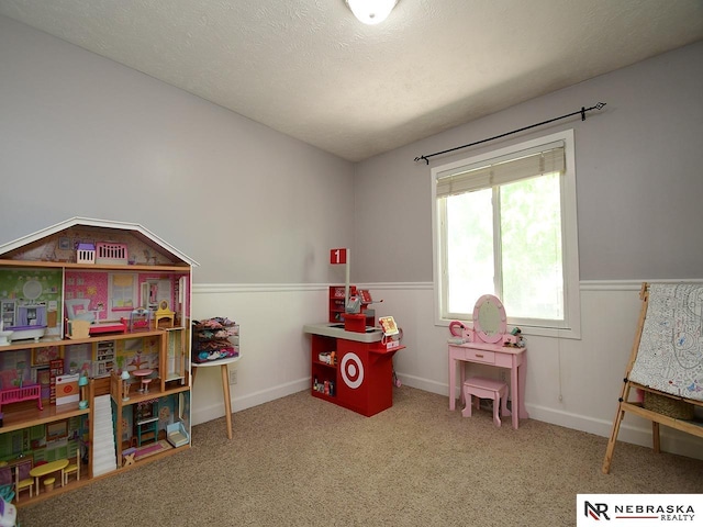 recreation room featuring carpet flooring and wainscoting