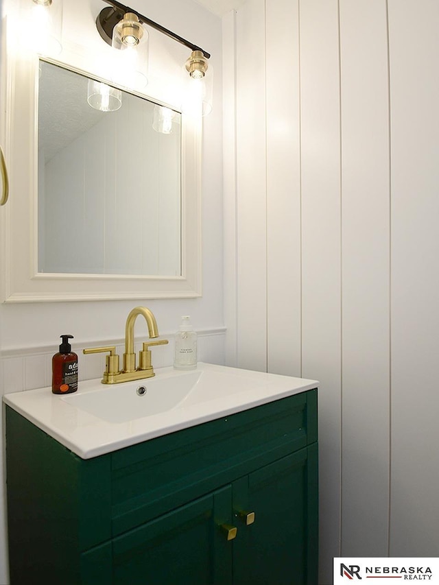 bathroom with vanity and a decorative wall