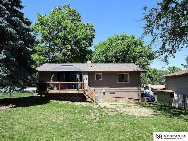 rear view of house featuring a wooden deck