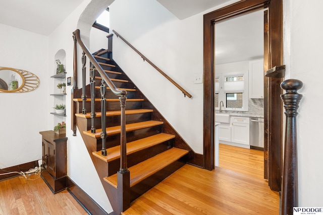 stairway featuring wood finished floors