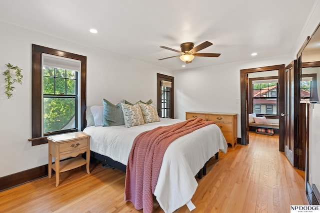bedroom with light wood finished floors, recessed lighting, baseboards, and ceiling fan