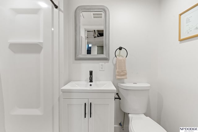 bathroom featuring vanity and toilet