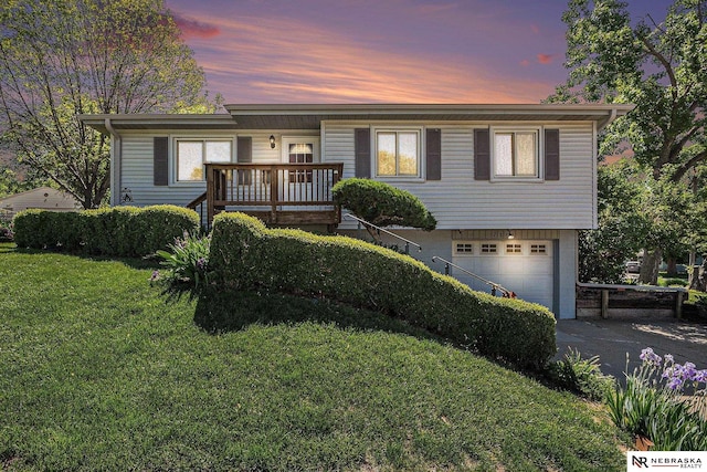 single story home with an attached garage, a yard, and driveway