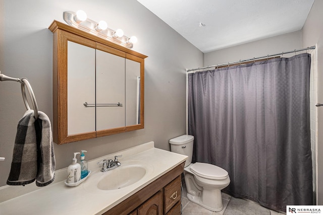 bathroom featuring vanity, toilet, a shower with curtain, and tile patterned floors