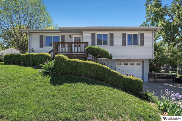 ranch-style house with an attached garage, a front lawn, and driveway
