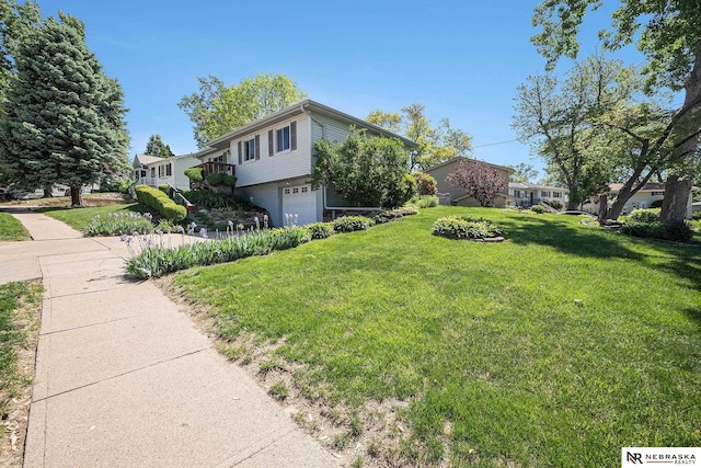 view of home's exterior with a garage and a yard
