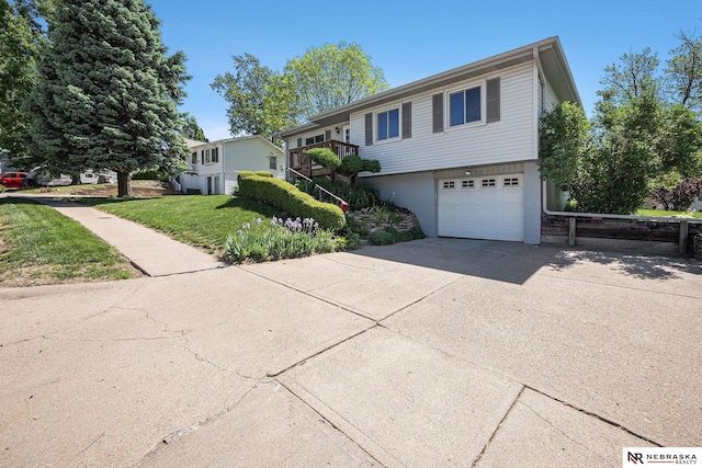 view of front facade featuring a garage, concrete driveway, and a front lawn