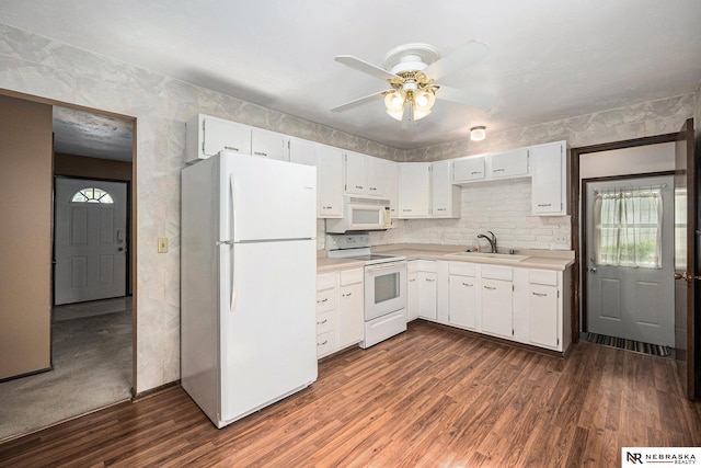 kitchen with white appliances, light countertops, a sink, a ceiling fan, and healthy amount of natural light