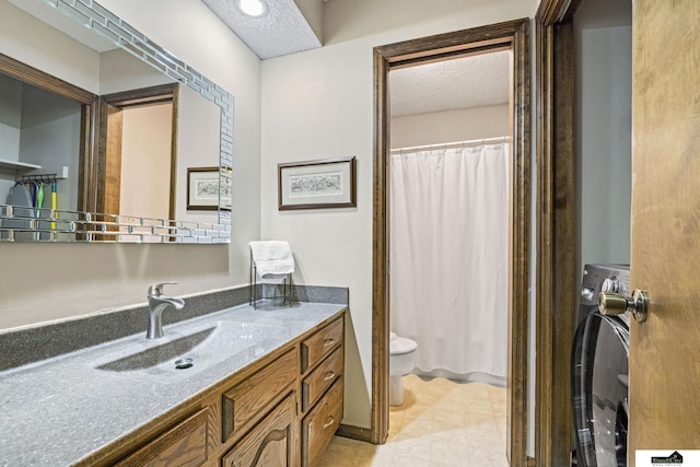 3041 Orwell St, Lincoln, NE 68516 - bathroom featuring washer / dryer, toilet, a textured ceiling, vanity, and a shower with curtain