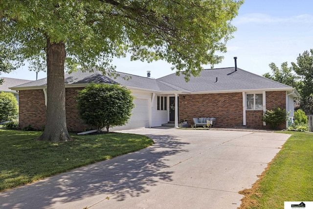 3041 Orwell St, Lincoln, NE 68516 - ranch-style house featuring an attached garage, driveway, a front yard, and brick siding