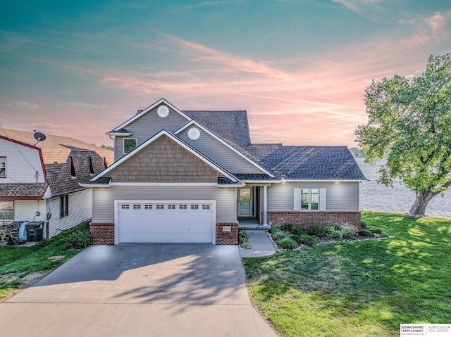 craftsman inspired home featuring brick siding, an attached garage, and concrete driveway