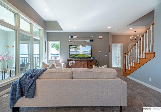 living area with plenty of natural light, baseboards, a chandelier, carpet, and recessed lighting