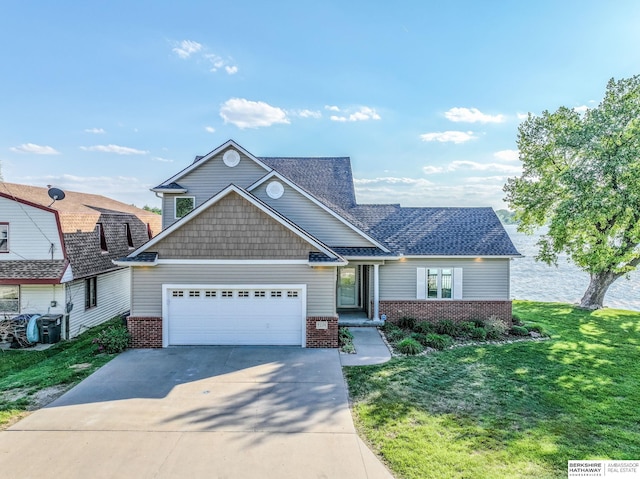 view of front of house with brick siding, an attached garage, concrete driveway, and a front yard