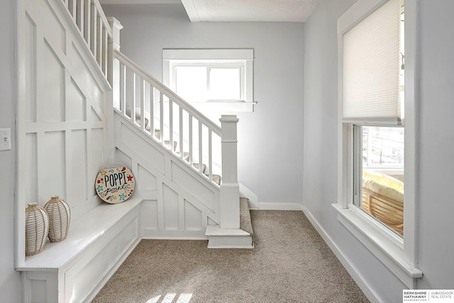staircase with carpet floors and baseboards