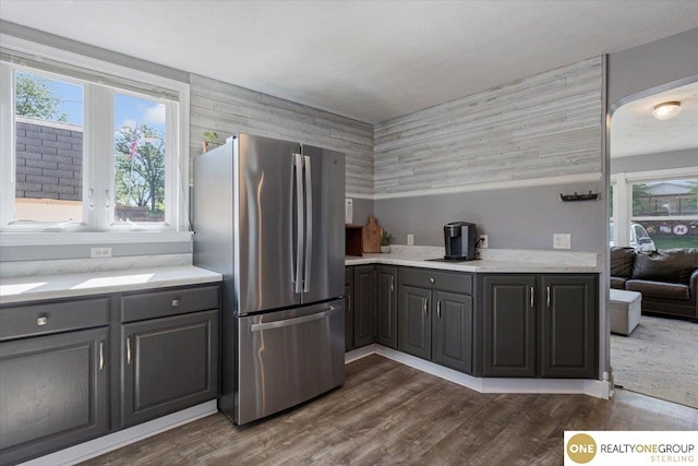 kitchen featuring freestanding refrigerator, gray cabinets, and dark wood-style floors