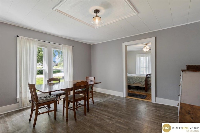 dining area featuring wood finished floors and baseboards