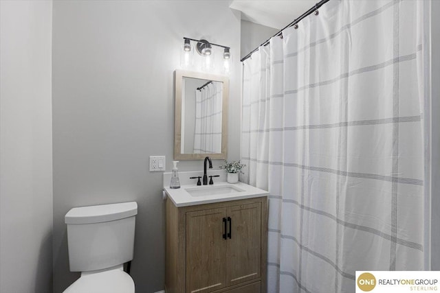 bathroom with toilet and vanity