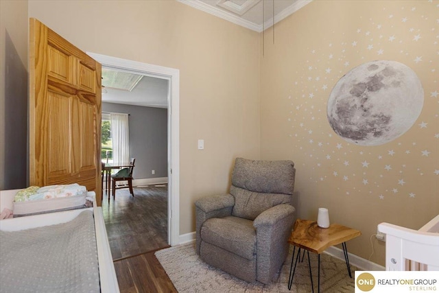 bedroom with crown molding, dark wood finished floors, baseboards, and attic access