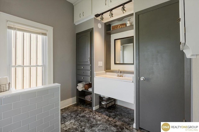 bathroom with vanity and baseboards