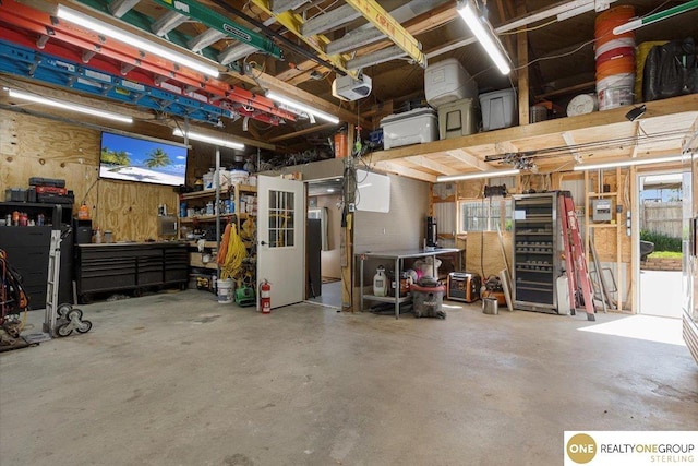 garage with a workshop area and a garage door opener