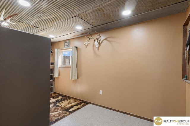 hall with recessed lighting and baseboards
