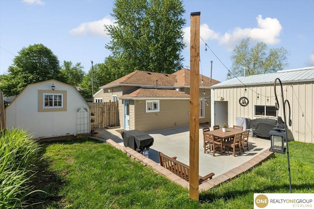 rear view of house with a patio area, an outbuilding, and a storage unit