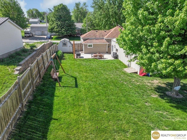 view of yard with a patio area, a storage shed, an outdoor structure, and a fire pit