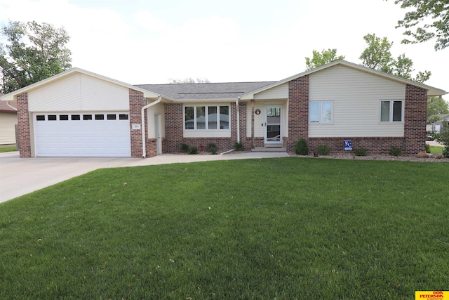 2804 Hogan Ln, Fremont, NE 68025 - ranch-style house featuring a garage, concrete driveway, a front yard, and brick siding