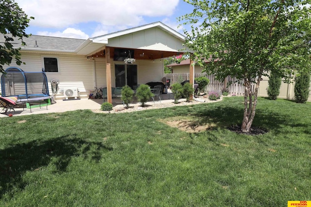 2804 Hogan Ln, Fremont, NE 68025 - back of house featuring a patio area, a trampoline, and roof with shingles
