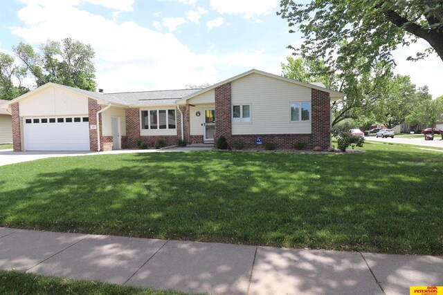 2804 Hogan Ln, Fremont, NE 68025 - view of front of property featuring an attached garage, brick siding, a front lawn, and concrete driveway