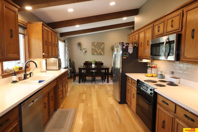 2804 Hogan Ln, Fremont, NE 68025 - kitchen featuring appliances with stainless steel finishes, a sink, brown cabinets, tasteful backsplash, and recessed lighting