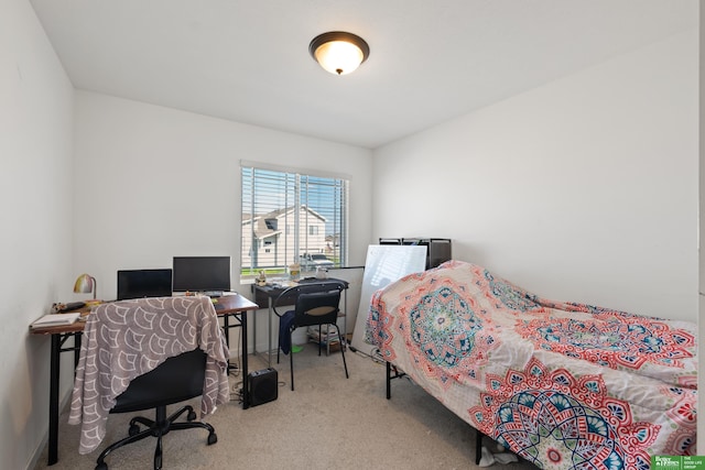 carpeted bedroom featuring a desk